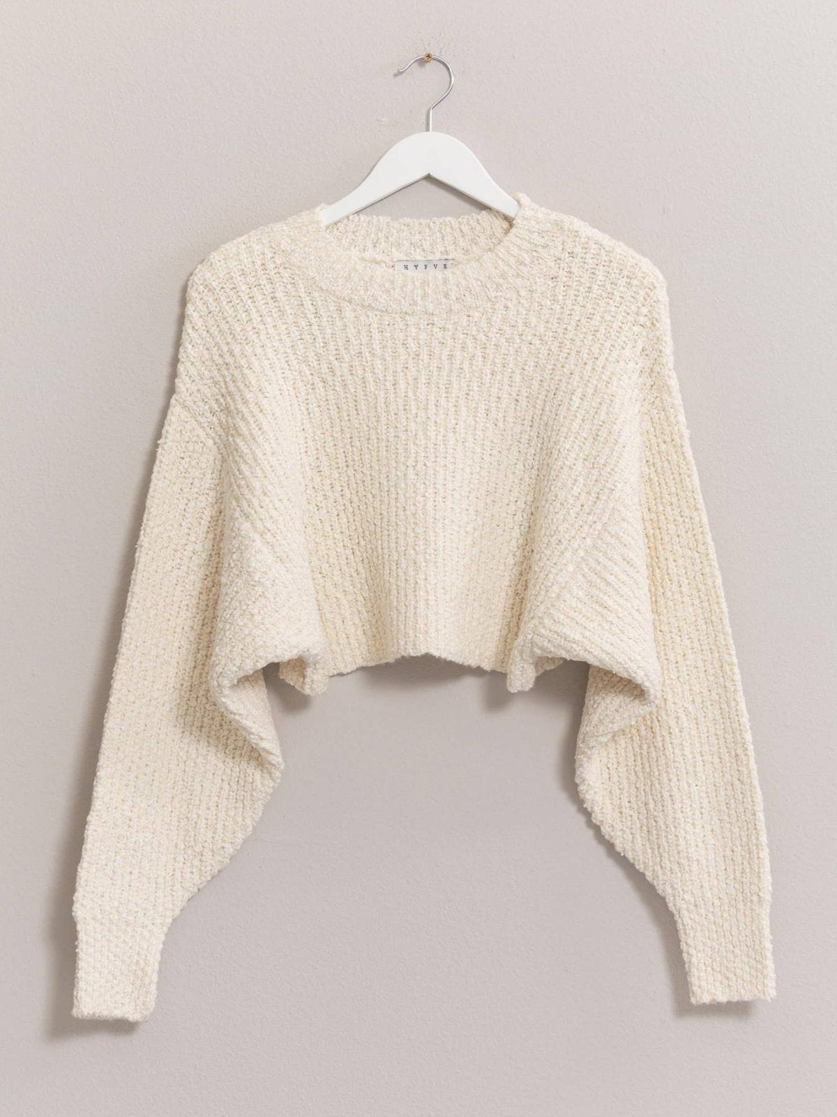 **Alt Text:**  
Model wearing the Cozy Popcorn Knit Pullover in a cropped silhouette with a mock neck, long sleeves, and drop shoulders. The textured popcorn knit fabric adds a stylish touch, paired with casual joggers for a relaxed, effortless look.